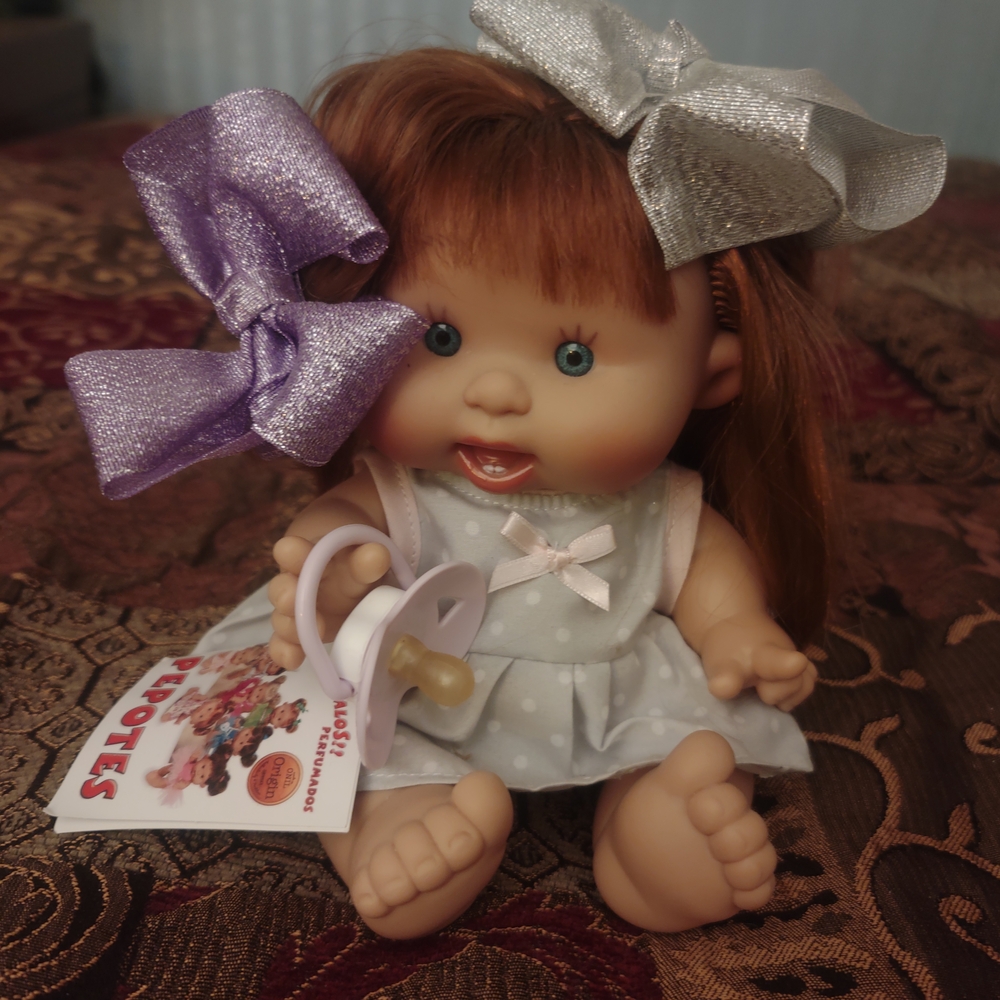 Adorable Baby Doll with Silver and Purple Bows